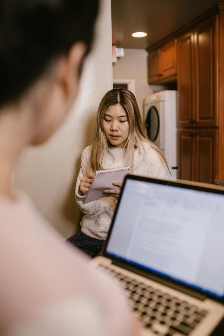 Woman in White Long Sleeve Shirt Using Macbook Pro